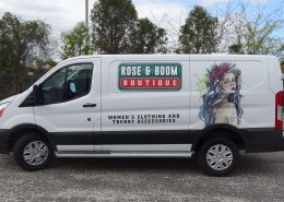 vinyl graphics and watercolor-style illustration are striking on the side of a white van.