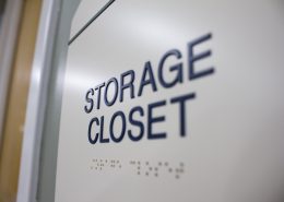 ADA sign with raised lettering and Braille reading "Storage Closet"