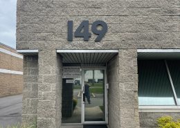 black building numbers 149 on an exterior wall